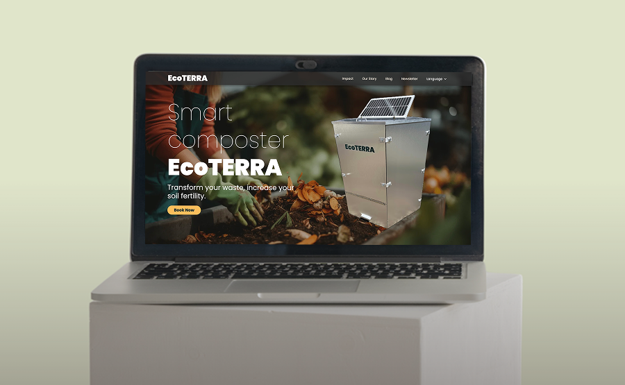 Laptop displaying EcoTERRA website featuring a smart composter with a solar panel on top and a background of compost materials.